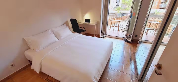 Main bedroom: queen bed and balcony doors